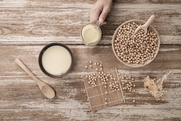 Soy milk and soy bean on wooden background