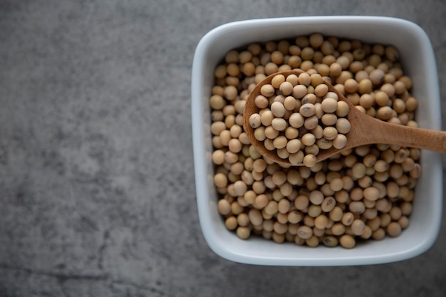 Soybean raw food nutrition in wooden spoon on a bowl