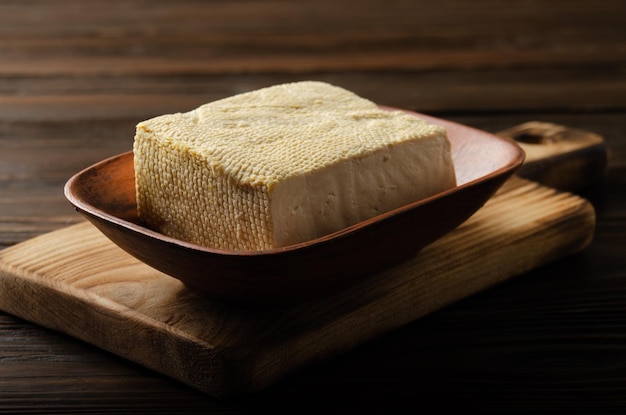 Soybean tofu vegetable bean curd in clay bowl on kitchen table