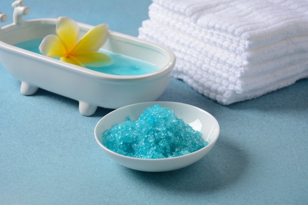 Spa and body care products. Aromatic blue bath Dead Sea Salt on the blue  background. Natural ingredients for homemade body salt scrub. Dead Sea cosmetics. Beauty skin care. Spa treatment.