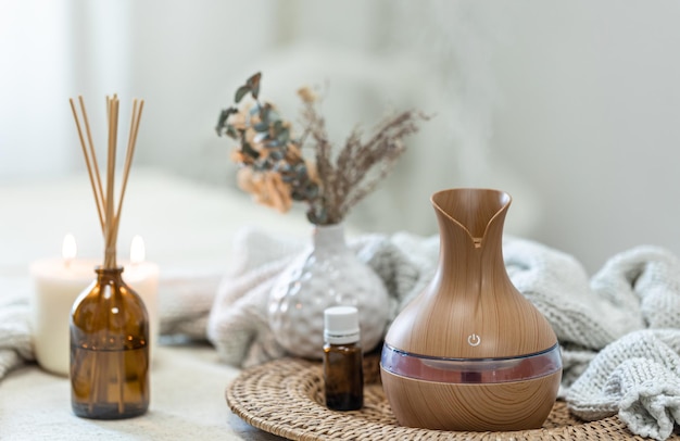 Spa composition with aroma oil diffuser lamp on a blurred background