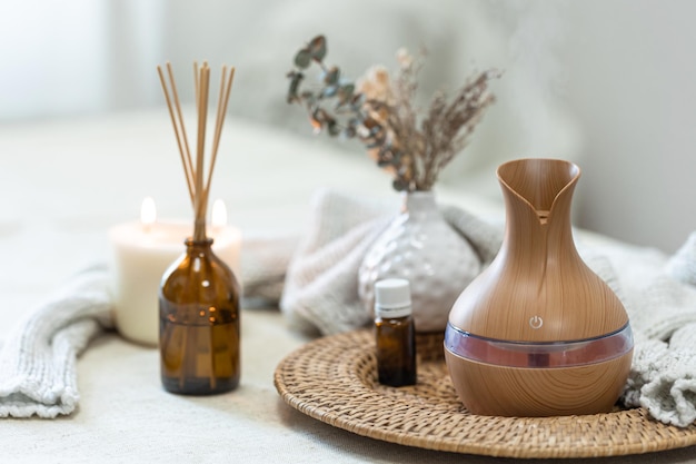 Spa composition with aroma oil diffuser lamp on a blurred background