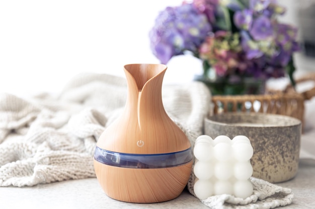 Spa composition with aroma oil diffuser lamp and candle on a blurred background