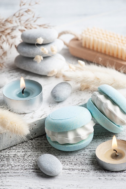 Spa composition with bath bomb macaroon and dry flowers on rustic table in monochrome style. Candles and salt. Beauty treatment and relax