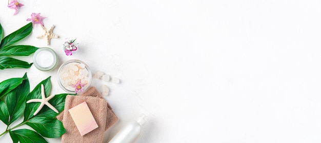 Spa composition with towel soap cream and fresh flowers