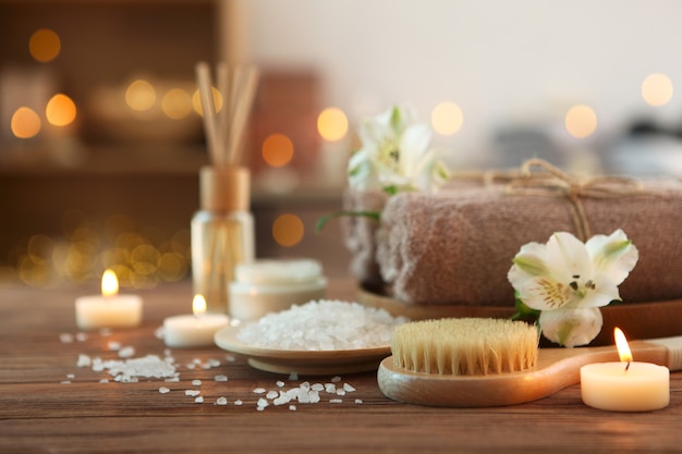 Spa composition with towels and care products on the table with place for text