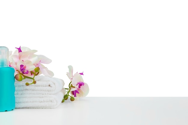 Spa composition with towels and flowers isolated on white