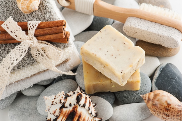 Spa composition with towels, lit candle, soap