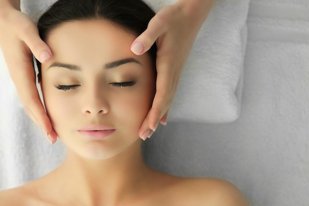 Spa concept Face massage Young woman getting spa treatment close up