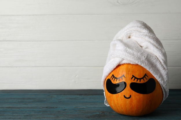 Spa concept with pumpkin on wooden background