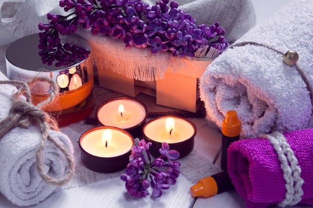 SPA consist from towels, lilac, candles, cream and oil 