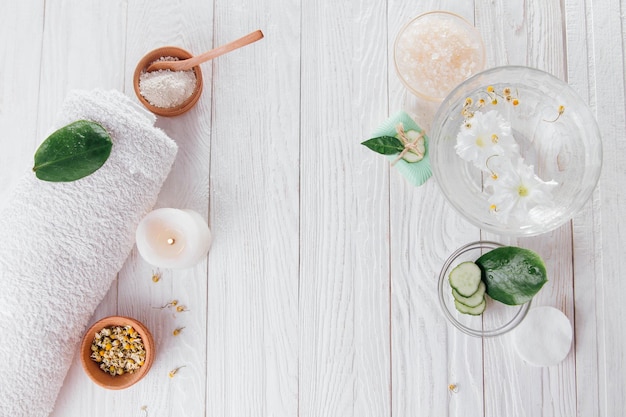 Spa essentials including candle salt herbs and white clay