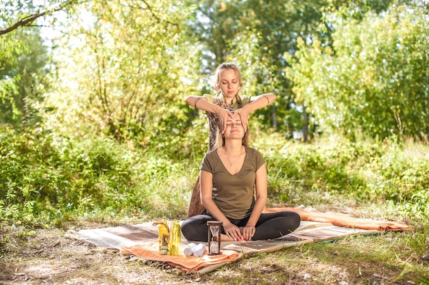 Spa massage Massage and aromatherapy women on the forest ground with a healer