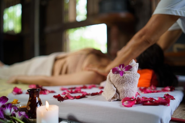 Spa massage wellness decorations while masseuse treatment of office syndrome traditional thai massage style female masseuse doing massage treat back pain arm pain and stress for office woman tired