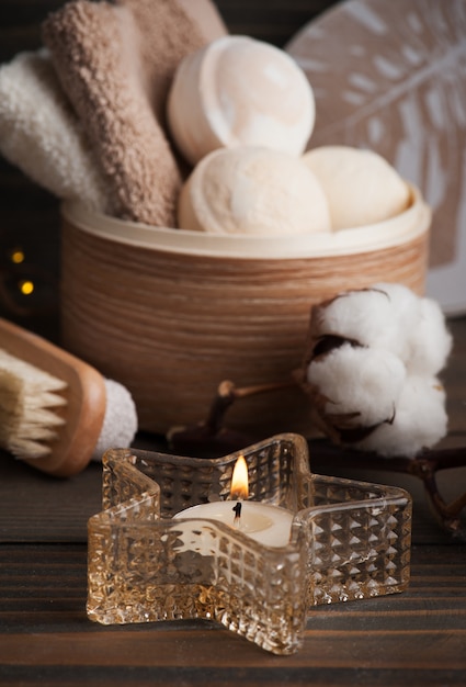 Spa products with golden candle and cotton