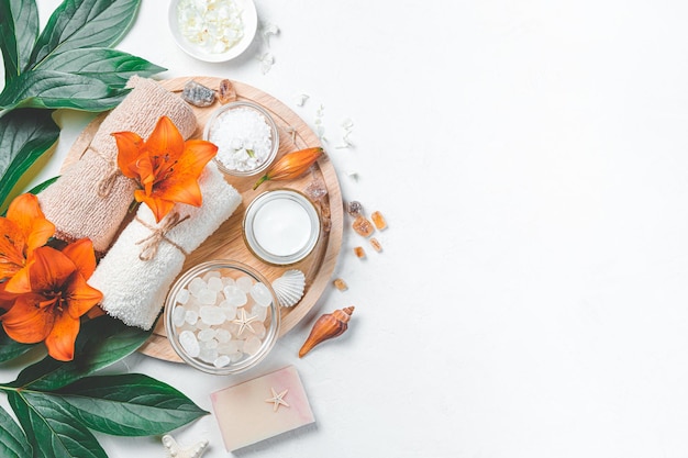 Spa set with flowers and care accessories on a light background