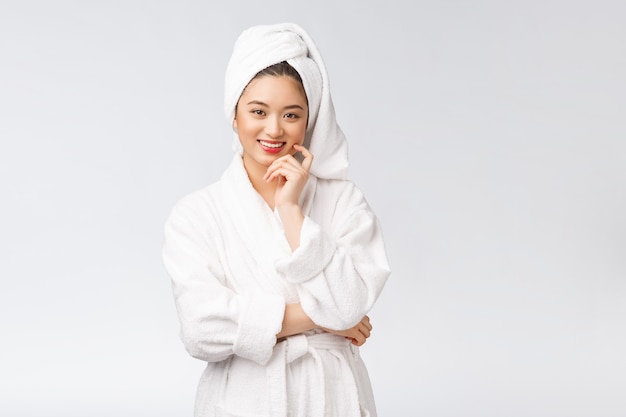 Spa skincare beauty Asian woman drying hair with towel on head after shower treatment Beautiful multiracial young girl touching soft skin