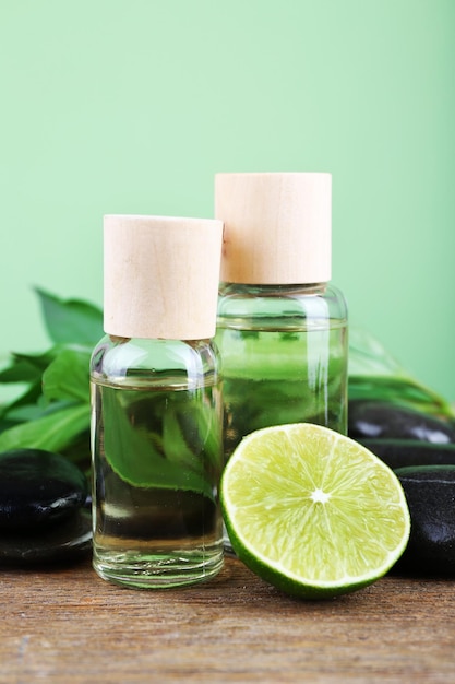 Spa still life in green color on wooden table on green background