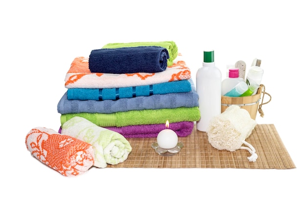 Spa still life Personal hygiene items towels different colors and natural sponge on a table closeup