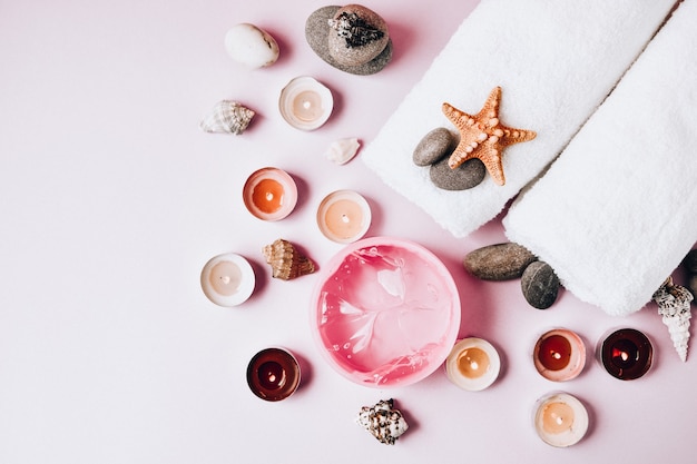 Spa still life treatment with candles, stones, sea shells starfish and towels