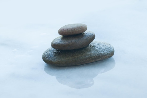 Spa stones on white table with sunlight