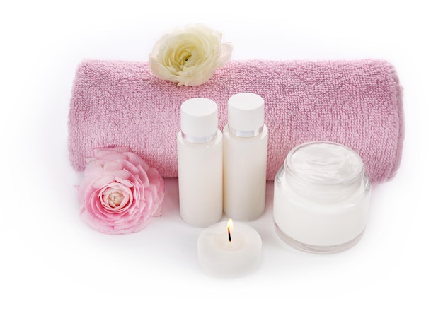 Spa treatment with towel and cream isolated on white