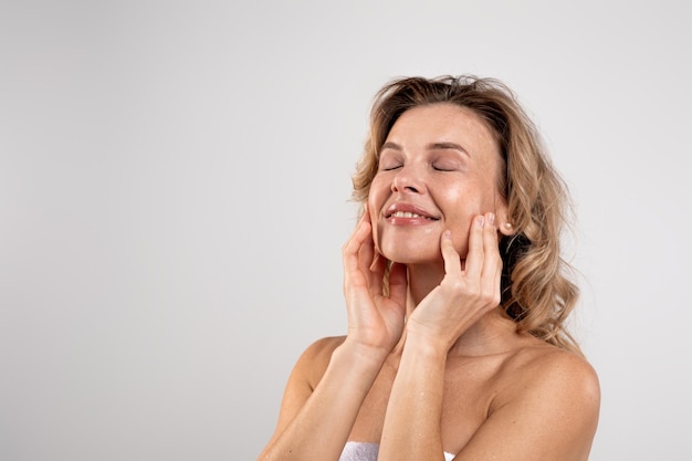 Spa Treatments Attractive Middle Aged Woman With Beautiful Skin Touching Her Face