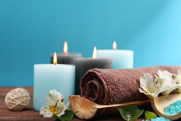 Spa treatments on wooden table against blue background