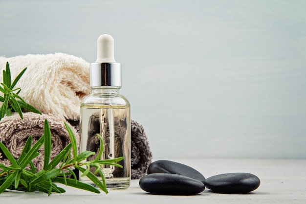 Spa and wellness composition with serum, towels and beauty products.