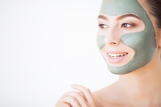 Spa Woman applying Facial cleansing Mask Beauty Treatments