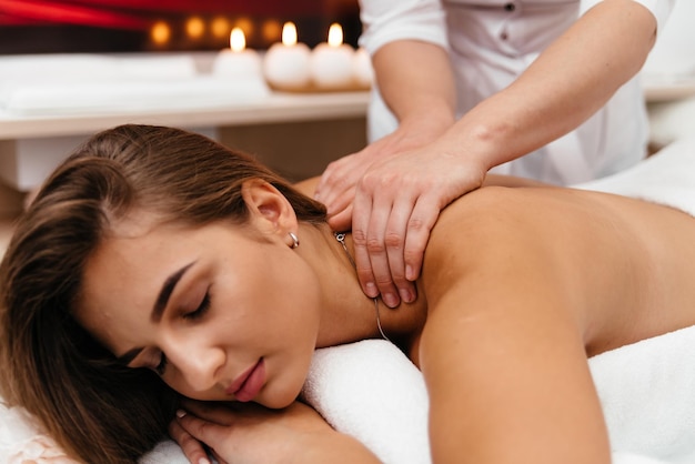 Spa woman Female enjoying relaxing back massage in cosmetology spa centre Body care skin care wellness wellbeing beauty treatment concept