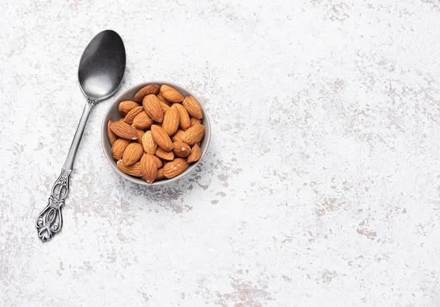 Space spoon with almond food background