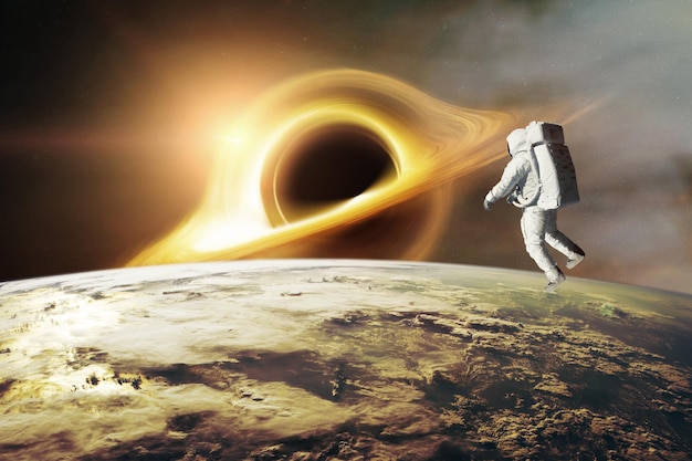 Spaceman looks at black hole on loworbit of Earth planet Elements of this image furnished by NASA