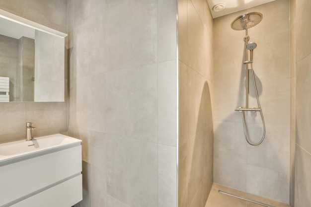 Spacious beige bathroom with shower cabin