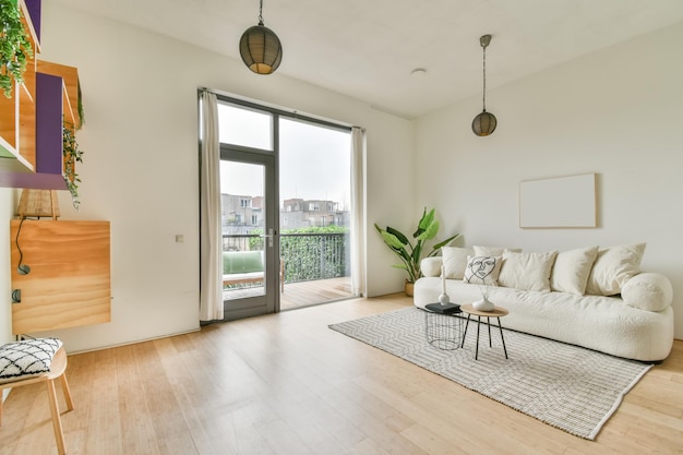 A spacious bright living room with a large white sofa on the carpet in a cozy house