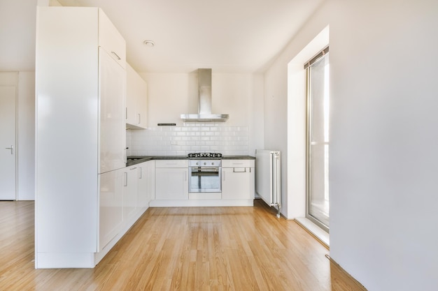 Spacious bright white kitchen with corridor