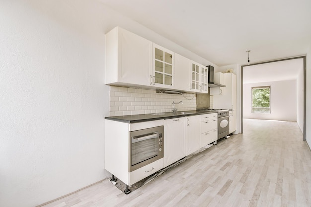 Spacious bright white kitchen with windows