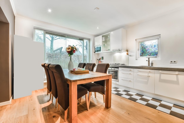 Spacious dining room with a full wellequipped kitchen in a cozy house and a panoramic window