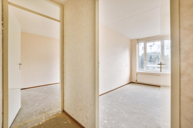 Spacious empty room with light wallpaper