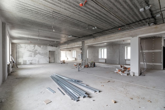 Spacious empty rooms in the attic floor after filling out the work on the wall and ceiling