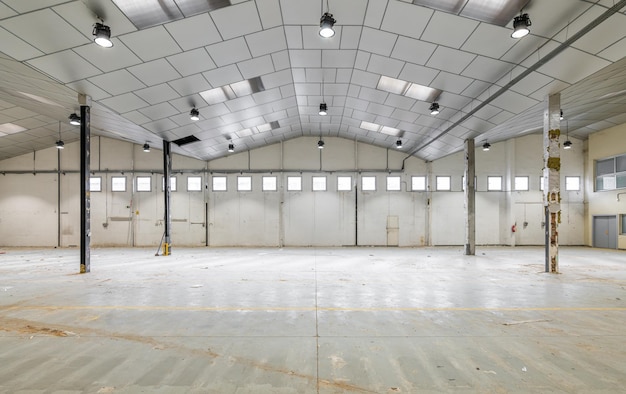 Spacious large room for a warehouse or parking with windows with metal pillars and a ceiling