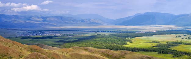 Spacious mountain valley. Cloudy weather. The contrast of dark clouds and light.