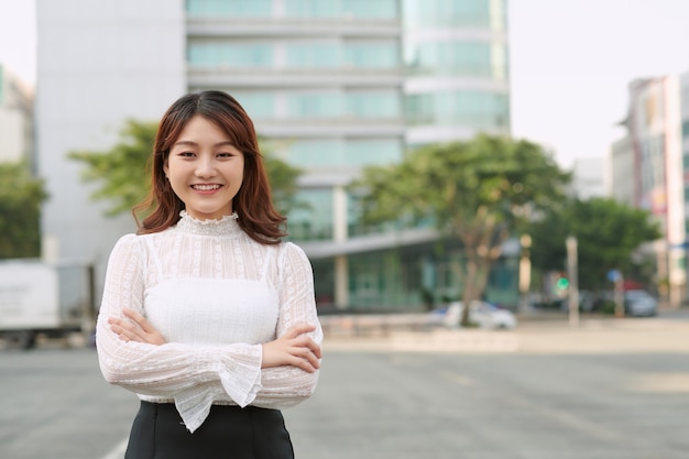 Spacious portrait of an attractive young executive business woman in a city street