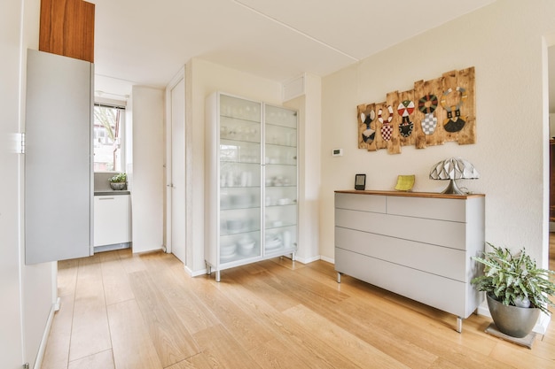 Spacious room with white cupboard transparent doors and installation over cabinet