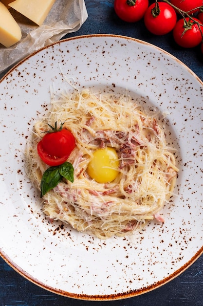 Spaghetti alla carbonara with bacon egg parmesan cheese and cream sauce Top view Closeup