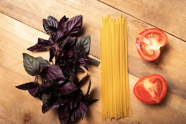 Spaghetti and basil on wooden table. Pasta Ingredients