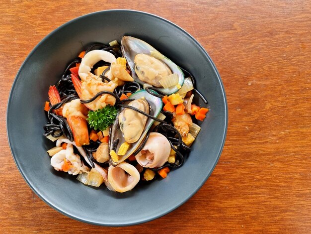 The spaghetti black squid with seafood such as prawn calamari mussel and vegetables