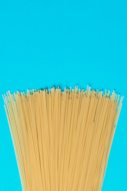 Spaghetti on a blue background. Top view.