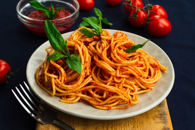 Spaghetti bolognese in a plate on blue