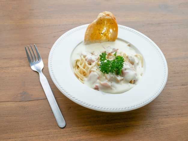 Spaghetti cream with bacon and mushroom on wood table. top view.